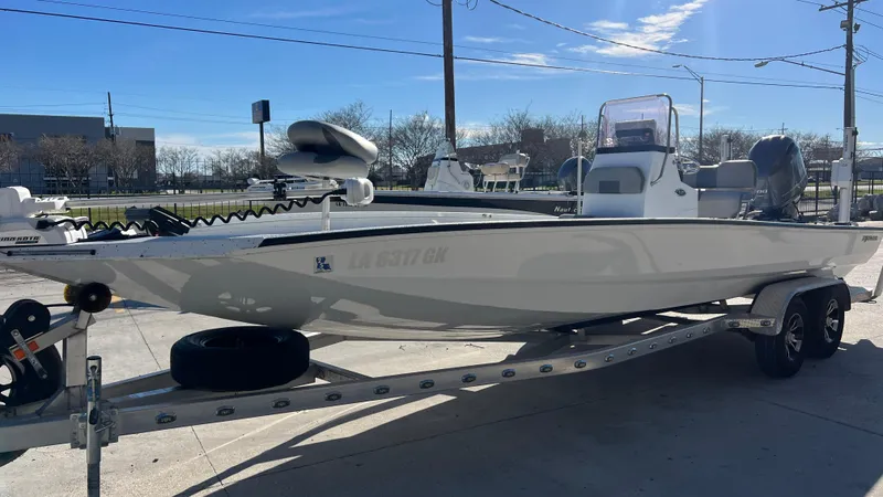 Slide: The Image of 2019 Xpress H24B boat on a trailer in a parking lot. - 4