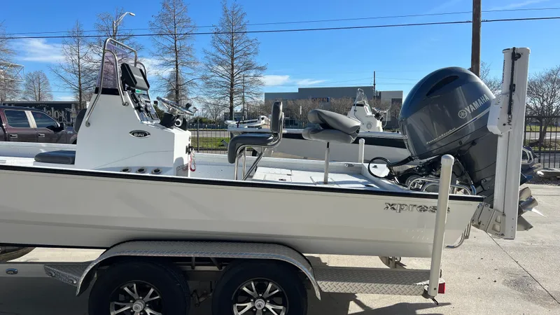 Slide: The Image of 2019 Xpress H24B boat on a trailer with Yamaha outboard motor. - 5