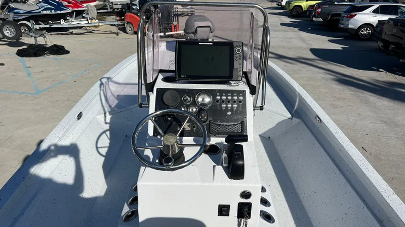 Slide: The Image of 2019 Xpress H24B boat console with steering wheel and navigation system. - 6
