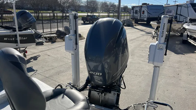 Slide: The Image of 2019 Xpress H24B boat with a 200 HP outboard motor in a marina. - 7