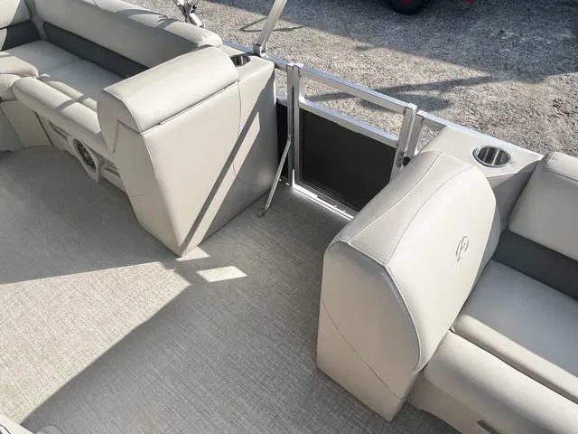 Slide: The Image of 2024 Avalon VTX 19 Cruise boat interior with beige seating and cup holders. - 11