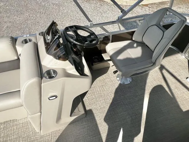 Slide: The Image of 2024 Avalon VTX 19 Cruise boat interior with steering console and captain's chair. - 12