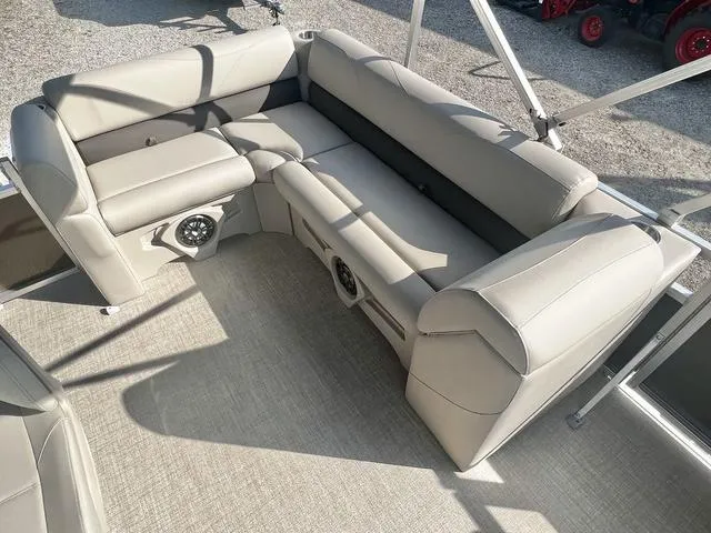 Slide: The Image of 2024 Avalon VTX 19 Cruise boat interior with beige seating and built-in speakers. - 13