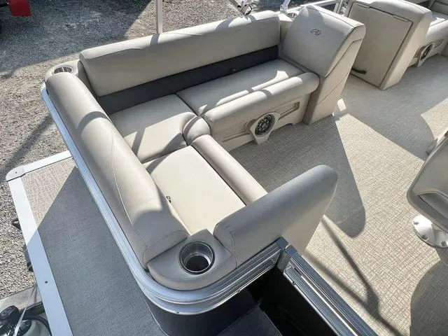 Slide: The Image of 2024 Avalon VTX 19 Cruise pontoon boat with beige seating and cup holders. - 18