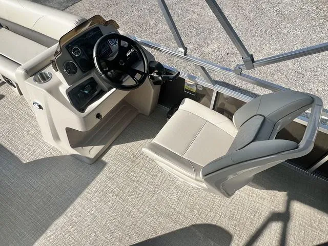 Slide: The Image of 2024 Avalon VTX 19 Cruise boat interior with captain's chair and steering console. - 19