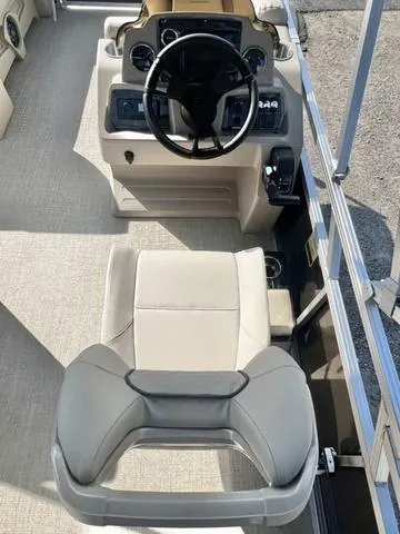 Slide: The Image of 2024 Avalon VTX 19 Cruise boat interior, featuring a steering wheel and captain's chair. - 20