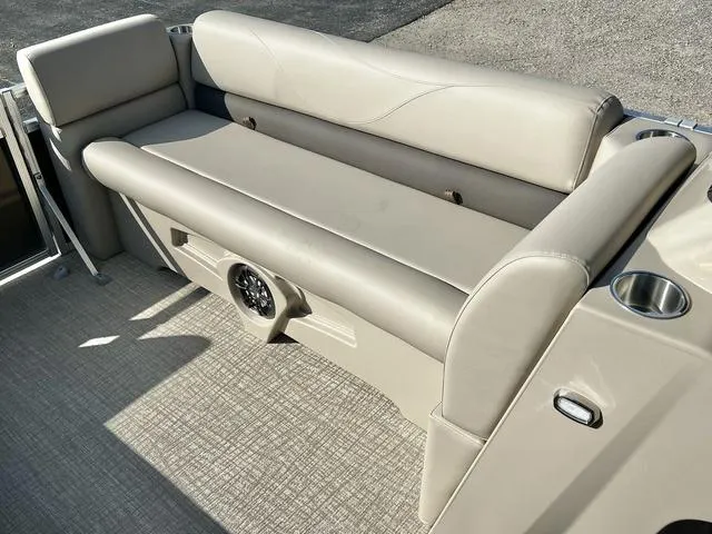 Slide: The Image of 2024 Avalon VTX 19 Cruise boat interior seating with built-in speaker and cup holders. - 24
