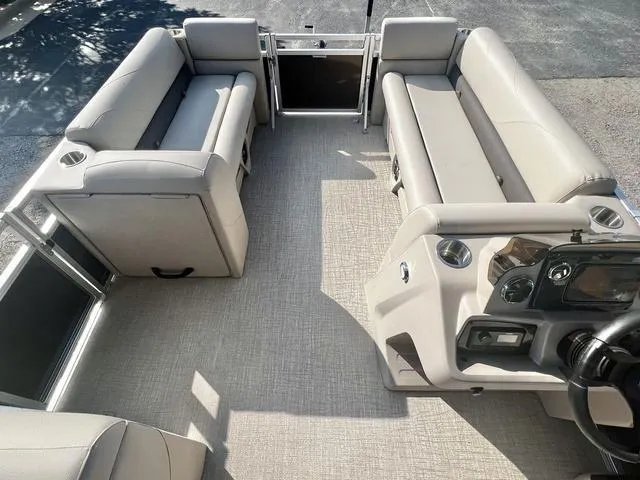 Slide: The Image of 2024 Avalon VTX 19 Cruise pontoon boat interior with spacious seating and modern helm. - 25