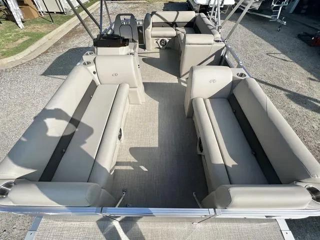 Slide: The Image of 2024 Avalon VTX 19 Cruise pontoon boat interior, beige seating, spacious layout. - 8