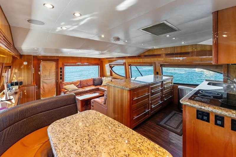 Slide: The Image of Luxurious interior of 2007 Hatteras 64 Convertible yacht with granite countertops and ocean view. - 10