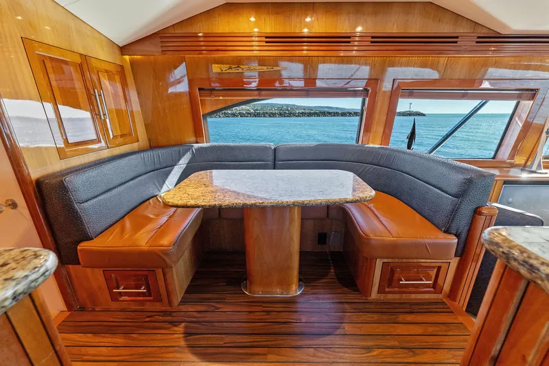 Slide: The Image of Luxurious interior of 2007 Hatteras 64 Convertible yacht with elegant dining area. - 12