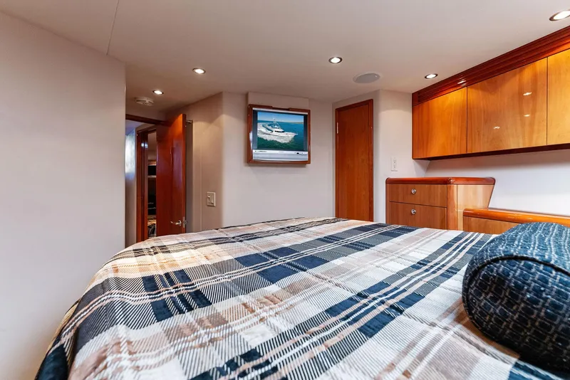 Slide: The Image of Interior cabin of 2007 Hatteras 64 Convertible yacht with plaid bedding. - 17
