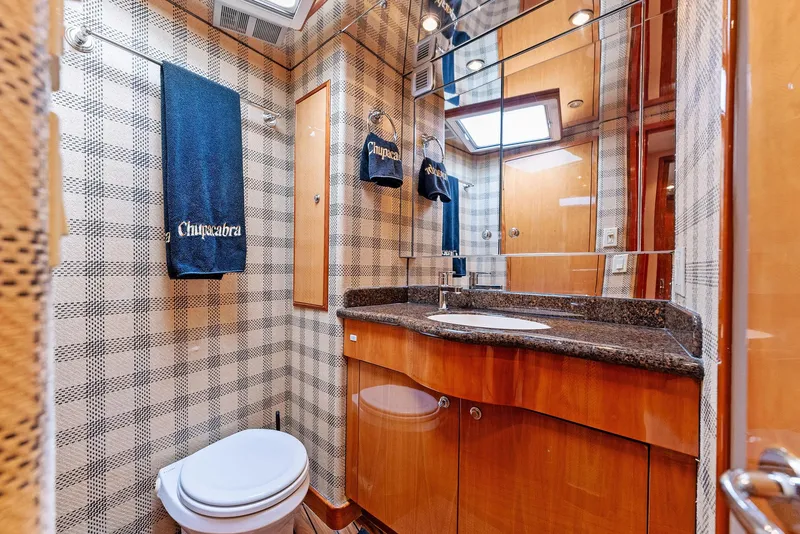 Slide: The Image of Luxurious bathroom in 2007 Hatteras 64 Convertible yacht with wood cabinetry and granite countertop. - 18