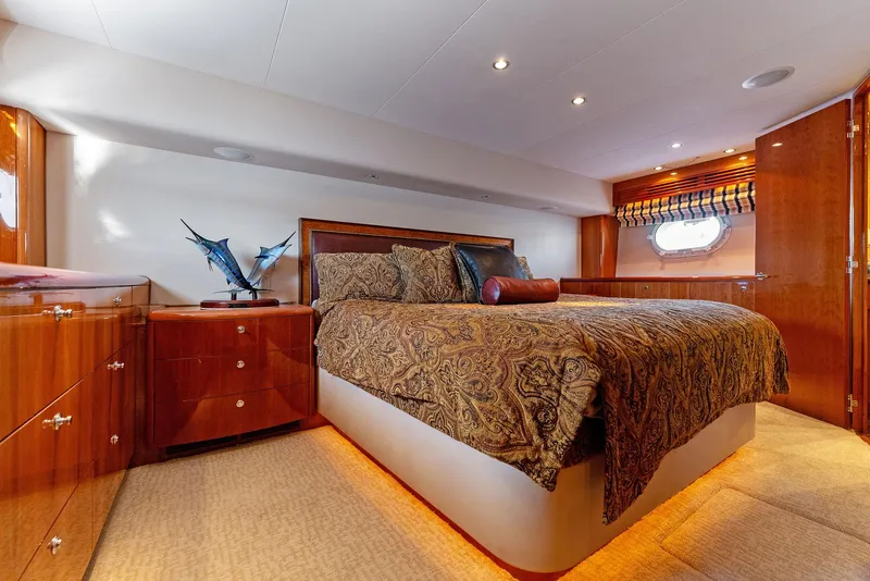Slide: The Image of Luxurious bedroom interior of 2007 Hatteras 64 Convertible yacht with elegant wood finishes. - 25