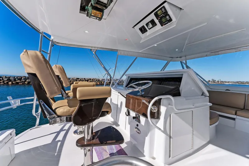 Slide: The Image of 2007 Hatteras 64 Convertible yacht helm with leather seats and ocean view. - 33