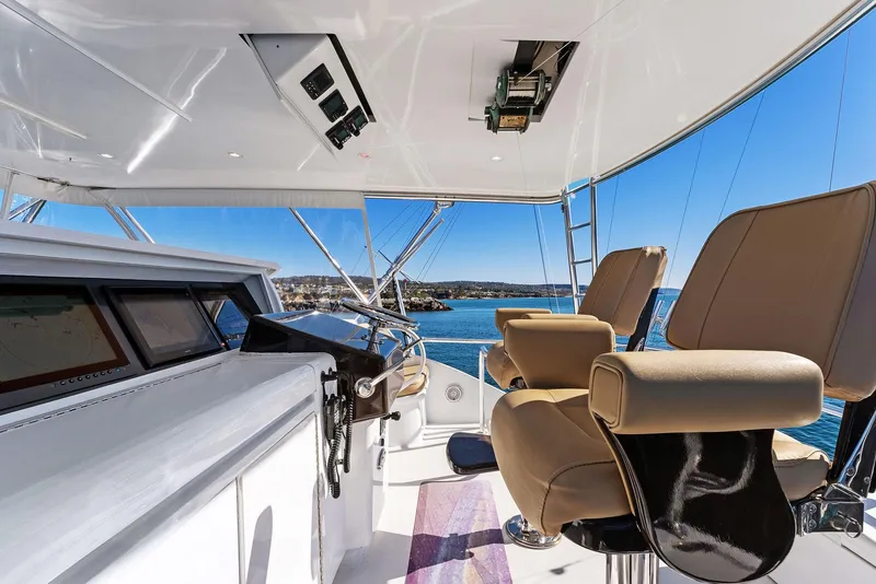 Slide: The Image of 2007 Hatteras 64 Convertible yacht helm with ocean view and captain's chairs. - 34