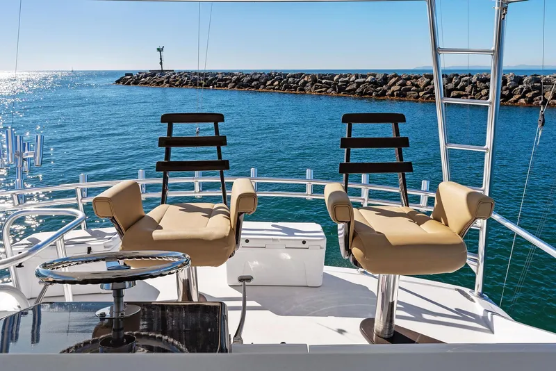 Slide: The Image of 2007 Hatteras 64 Convertible yacht with dual captain chairs on deck. - 36
