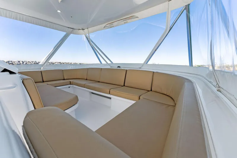 Slide: The Image of Spacious seating area on a 2007 Hatteras 64 Convertible yacht with panoramic windows. - 40