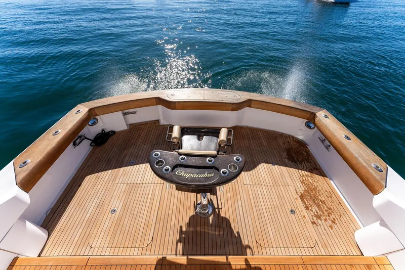 Slide: The Image of 2007 Hatteras 64 Convertible yacht stern with teak deck and fishing chair. - 44