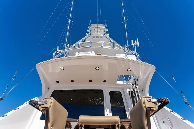 Slide: The Image of 2007 Hatteras 64 Convertible yacht, view from stern, clear blue sky background. - 45