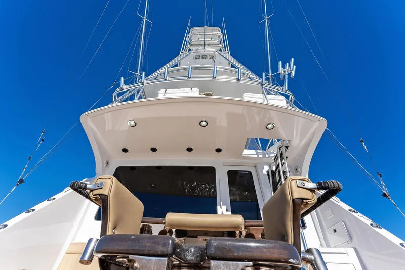 Slide: The Image of 2007 Hatteras 64 Convertible yacht, view from stern, clear blue sky. - 46