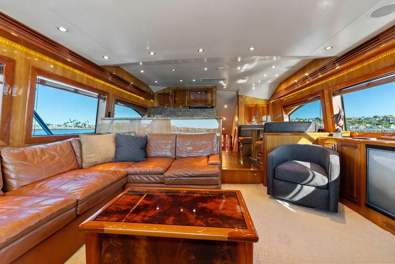 Slide: The Image of Luxurious interior of 2007 Hatteras 64 Convertible yacht with leather seating and wooden accents. - 5
