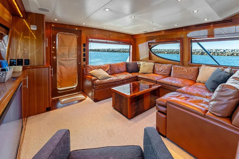 Slide: The Image of Luxurious interior of a 2007 Hatteras 64 Convertible yacht with leather seating and ocean view. - 6