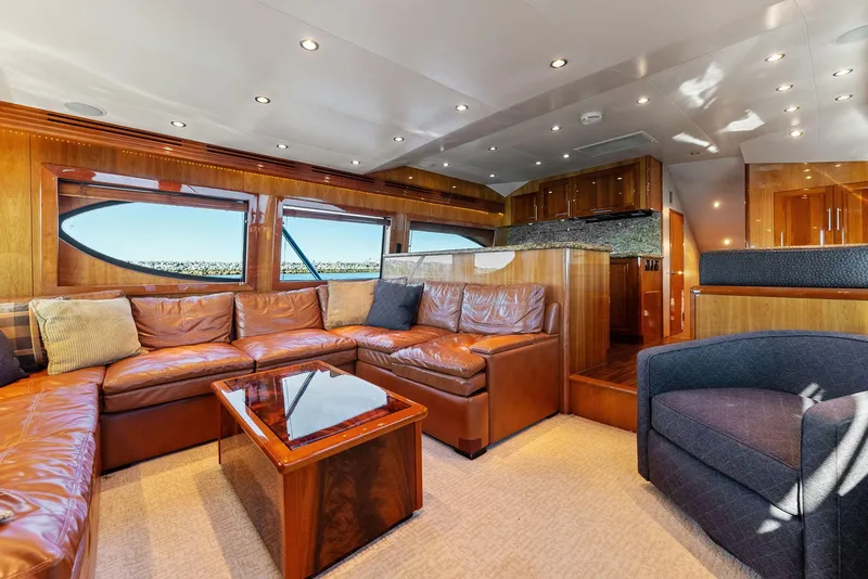 Slide: The Image of Luxurious interior of a 2007 Hatteras 64 Convertible yacht with leather seating and wooden finishes. - 7