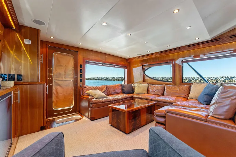Slide: The Image of Luxurious interior of a 2007 Hatteras 64 Convertible yacht with leather seating and panoramic windows. - 8