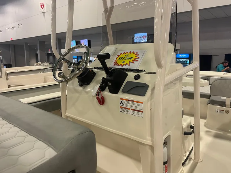 Slide: The Image of 2024 Carolina Skiff 24 Ultra Elite boat console at a showroom. - 22