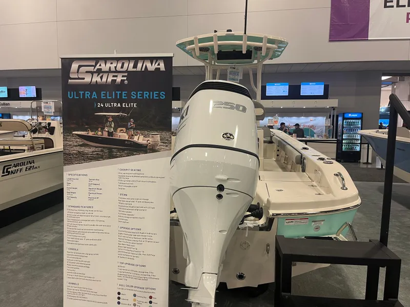 Slide: The Image of 2024 Carolina Skiff 24 Ultra Elite boat displayed at a boat show. - 24