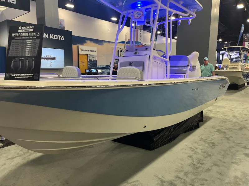Slide: The Image of 2024 Carolina Skiff 22 Ultra Elite boat displayed at an indoor boat show. - 12