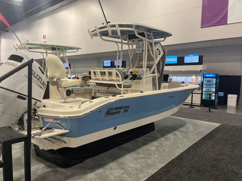 Slide: The Image of 2024 Carolina Skiff 22 Ultra Elite boat displayed at an indoor exhibition. - 13