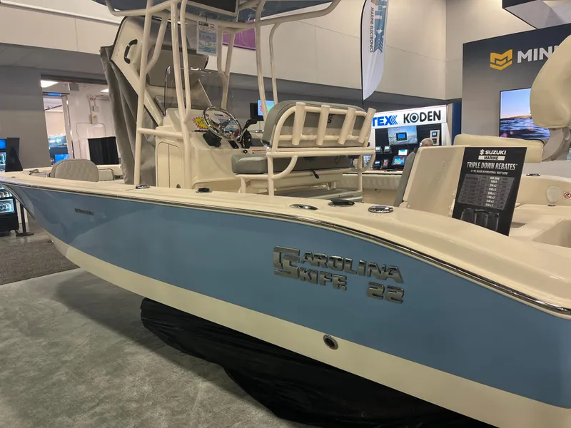 Slide: The Image of 2024 Carolina Skiff 22 Ultra Elite boat displayed at an indoor exhibition. - 14
