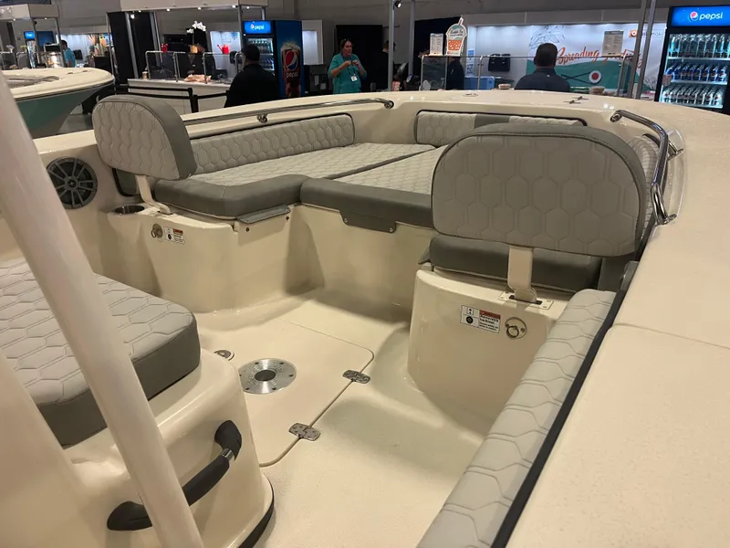 Slide: The Image of 2024 Carolina Skiff 22 Ultra Elite boat interior with cushioned seating at a boat show. - 17