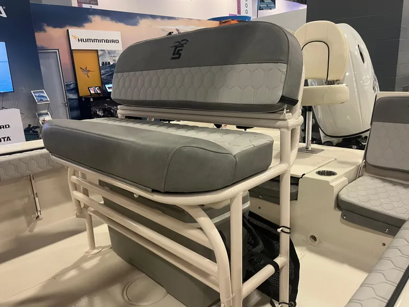 Slide: The Image of 2024 Carolina Skiff 22 Ultra Elite boat seating and console at a boat show. - 18