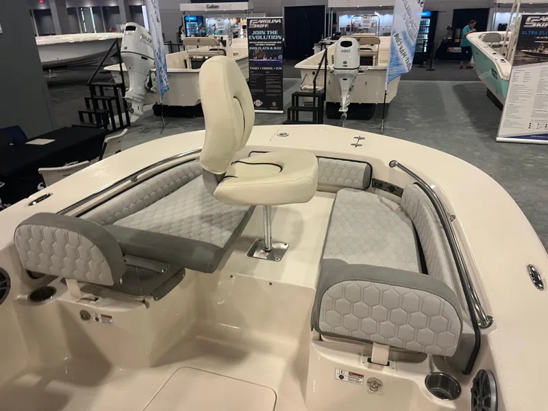 Slide: The Image of 2024 Carolina Skiff 22 Ultra Elite boat interior with cushioned seating and swivel chair. - 24