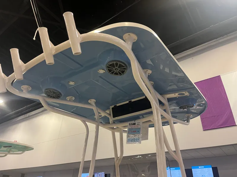 Slide: The Image of 2024 Carolina Skiff 22 Ultra Elite boat T-top with rod holders and speakers. - 8