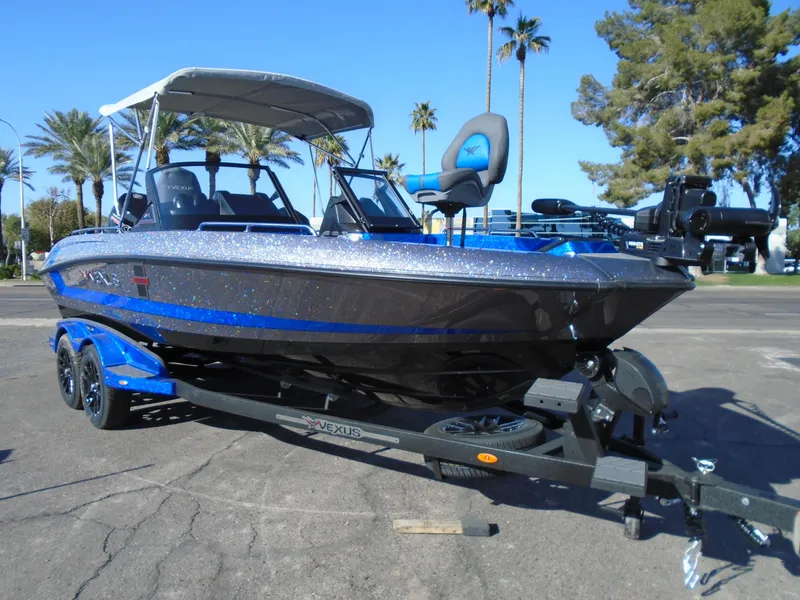 The Image of 2024 Vexus DVX20S boat on trailer with canopy in sunny outdoor setting. - 1