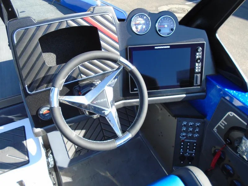 Slide: The Image of 2024 Vexus DVX20S boat dashboard with steering wheel, gauges, and touchscreen display. - 14