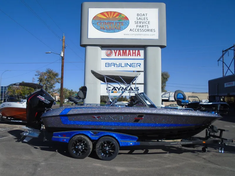 Slide: The Image of 2024 Vexus DVX20S boat on trailer at dealership with Yamaha and Bayliner signs. - 27