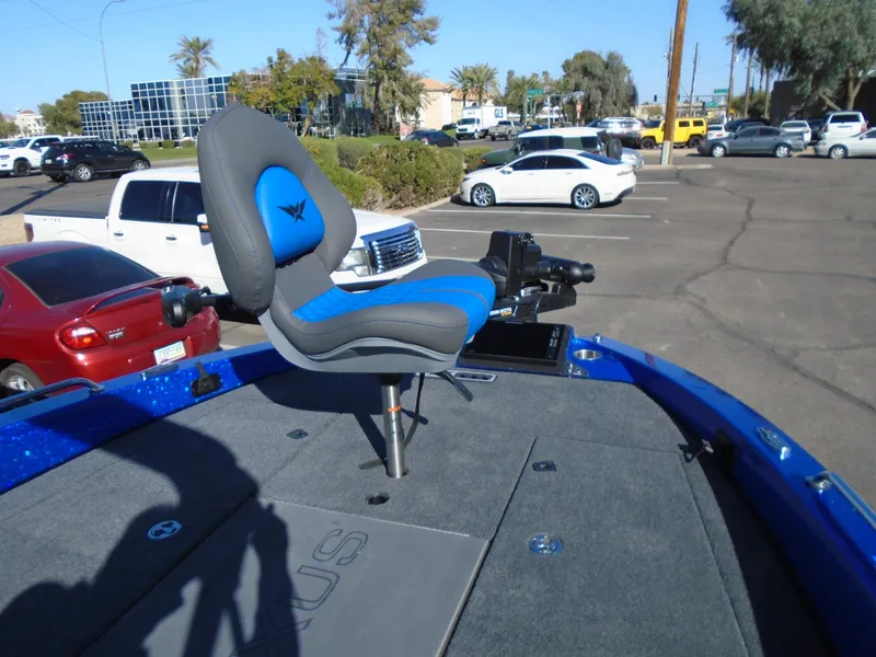 Slide: The Image of 2024 Vexus DVX20S boat with blue and gray seating in a parking lot. - 3