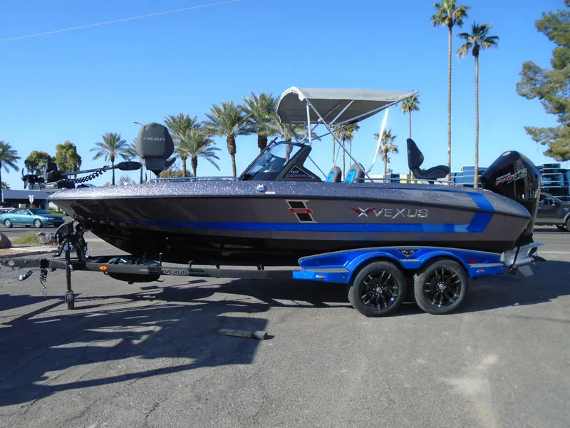 Slide: The Image of 2024 Vexus DVX20S boat on a trailer with palm trees in the background. - 5