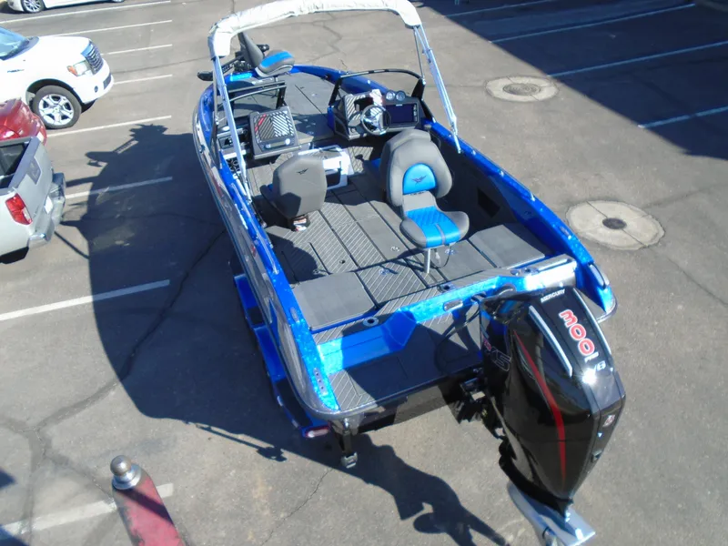 Slide: The Image of 2024 Vexus DVX20S blue fishing boat with outboard motor in parking lot. - 6