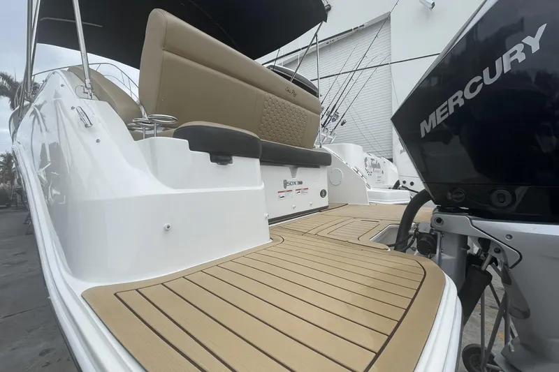 Slide: The Image of 2019 Sea Ray SDX 250 Outboard boat with Mercury engine, featuring spacious seating and deck. - 10
