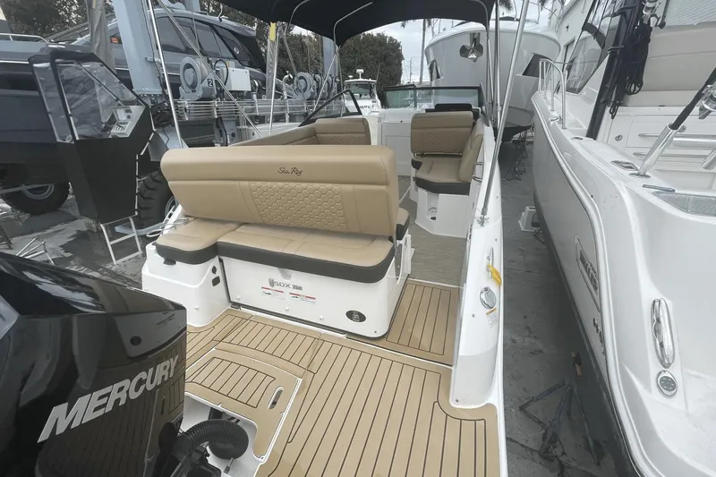 Slide: The Image of 2019 Sea Ray SDX 250 Outboard boat with tan seating and Mercury engine. - 11