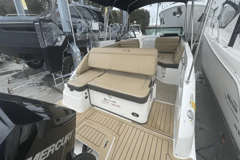 Slide: The Image of 2019 Sea Ray SDX 250 Outboard boat with tan seating and Mercury engine, docked. - 12