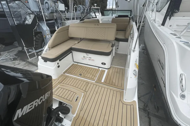 Slide: The Image of 2019 Sea Ray SDX 250 Outboard boat with tan seating and Mercury engine. - 13