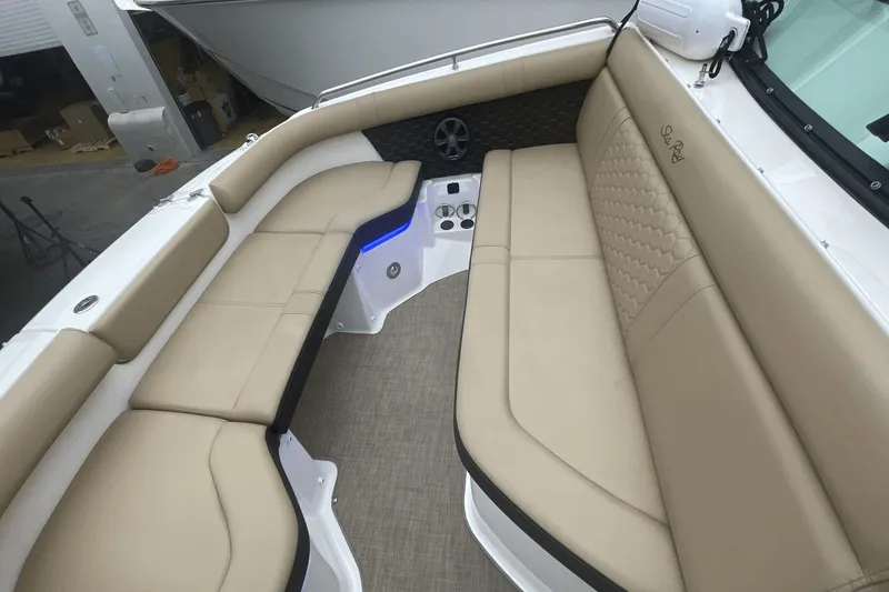 Slide: The Image of 2019 Sea Ray SDX 250 Outboard interior with beige seating and modern design. - 29