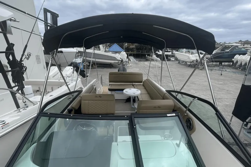 Slide: The Image of 2019 Sea Ray SDX 250 Outboard boat with canopy, docked at marina. - 31
